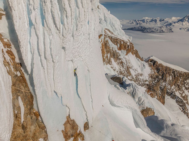 Colin Haley digs through rim ice while making the first winter solo of Cerro Torre.