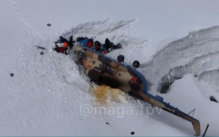The Russian Mi-8 helicopter lying partially in a crevasse on Pobeda Peak. Miraculously, no one was killed.